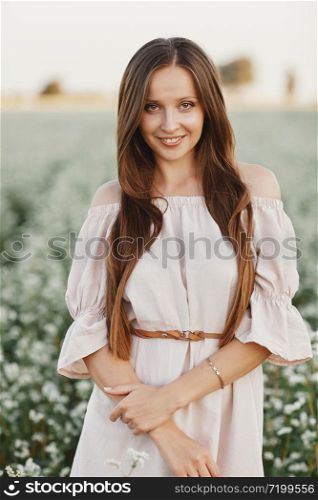 Beautiful woman enjoying field, happy young lady and spring green nature, harmony concept. portrait of a beautiful girl in a field of flowers. selective focus.. Beautiful woman enjoying field, happy young lady and spring green nature, harmony concept. portrait of a beautiful girl in a field of flowers. selective focus