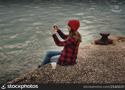 Beautiful woman enjoying her day taking pictures with her camera