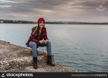 Beautiful woman enjoying her day taking pictures with her camera