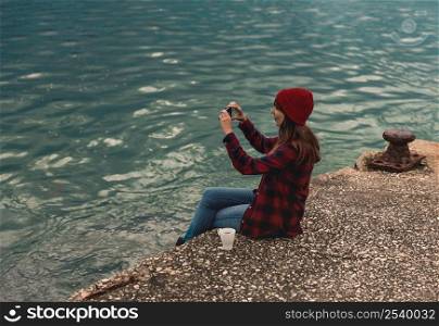 Beautiful woman enjoying her day taking pictures with her phone
