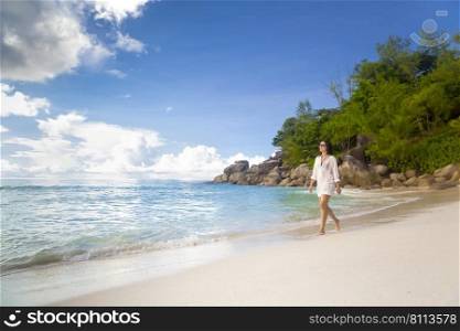 Beautiful woman enjoying the beautiful beachs of Praslin, Seychelles