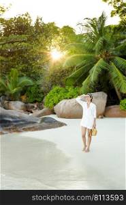 Beautiful woman enjoying the beautiful beachs of Praslin, Seychelles