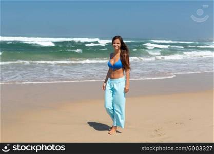 Beautiful woman exercising at the beach - fitness concept