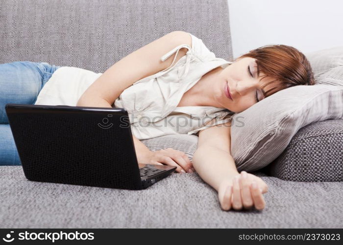 Beautiful woman exhausted after working with a laptop