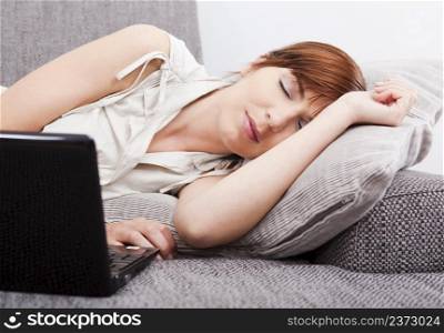 Beautiful woman exhausted after working with a laptop