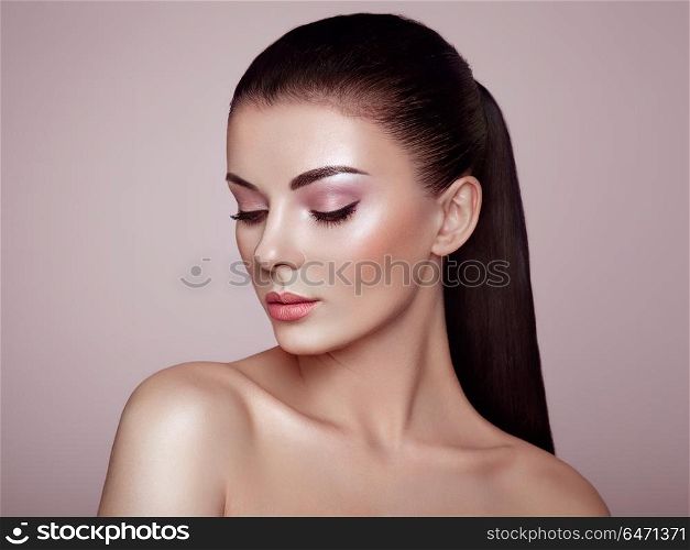 Beautiful woman face. Beautiful Young Woman with Clean Fresh Skin. Perfect Makeup. Beauty Fashion. Eyelashes. Cosmetic Eyeshadow. Highlighting. Cosmetology, Beauty and Spa
