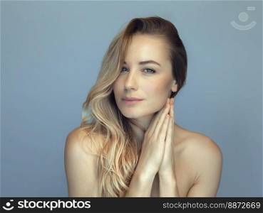 Beautiful woman fashion portrait. Perfect smooth skin and long blond hair. Natural makeup. Spa.. Beauty fashion portrait female face