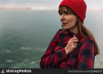 Beautiful woman felling cold near the lake