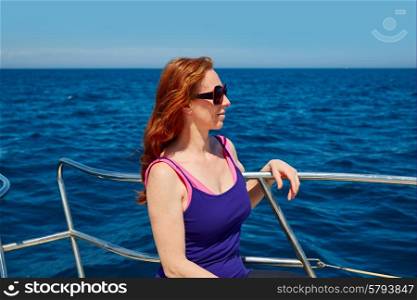 Beautiful woman girl in a boat relaxed profile portrait on the ocean sea