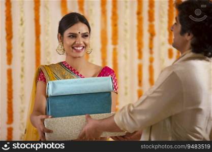  Beautiful woman giving presents to a young man