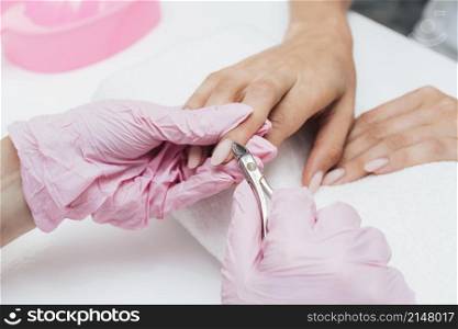 beautiful woman hands cutting cuticles