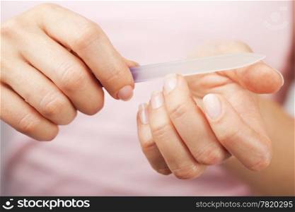 beautiful woman hands with nail file