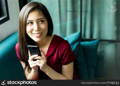 Beautiful woman happy with smartphone, Smiling woman holding smartphone in hands and looking up over happy.
