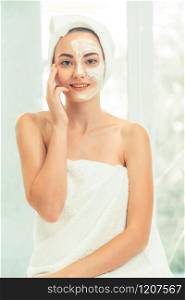Beautiful woman having a facial cosmetic scrub treatment from professional dermatologist at wellness spa. Anti-aging, facial skin care and luxury lifestyle concept.