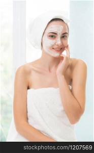 Beautiful woman having a facial cosmetic scrub treatment from professional dermatologist at wellness spa. Anti-aging, facial skin care and luxury lifestyle concept.. Beautiful woman having a facial treatment at spa.
