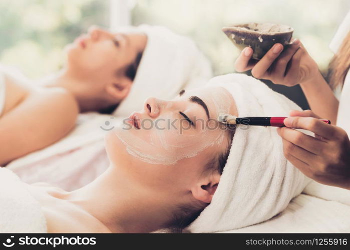 Beautiful woman having a facial cosmetic scrub treatment from professional dermatologist at wellness spa. Anti-aging, facial skin care and luxury lifestyle concept.