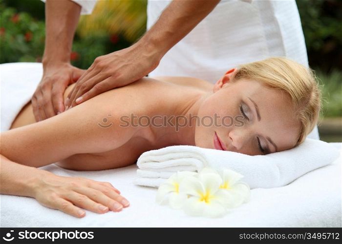 Beautiful woman having a massage on her back