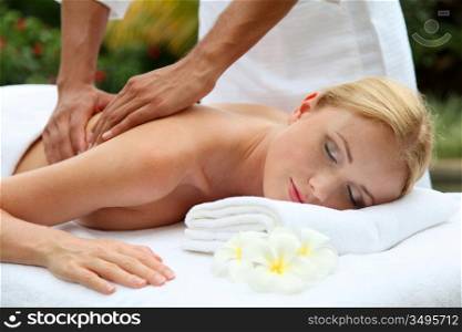 Beautiful woman having a massage on her back