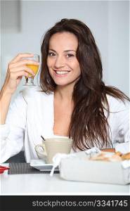 Beautiful woman having breakfast at home