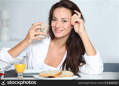 Beautiful woman having breakfast at home
