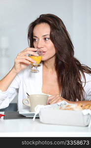 Beautiful woman having breakfast at home