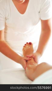 beautiful woman having leg and foot massage at the spa and wellness center