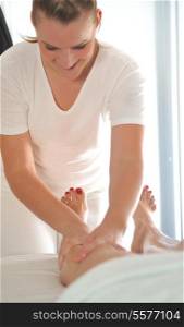 beautiful woman having leg and foot massage at the spa and wellness center