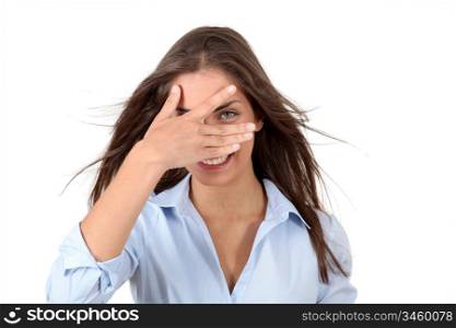 Beautiful woman hiding her eyes with fingers