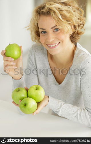 beautiful woman holding a green apples