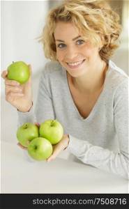 beautiful woman holding a green apples