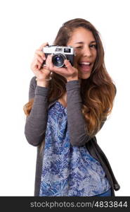 Beautiful woman holding a vintage camera, isolated over white background