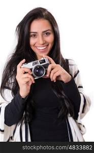 Beautiful woman holding a vintage camera, isolated over white background