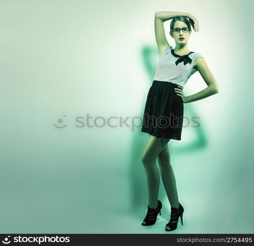 beautiful woman holding arm over her head. beautiful woman holding arm over her head in green light