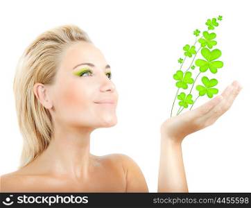 Beautiful woman holding fresh clover plant in hand, sensual female portrait isolated on white background, cute girl with bright green makeup, st.Patrick&rsquo;s day holiday