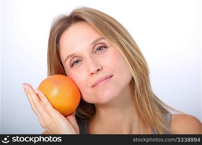 Beautiful woman holding grapefruit