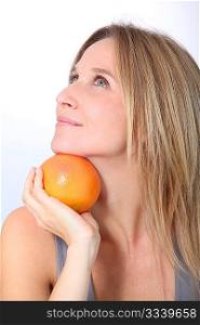 Beautiful woman holding grapefruit