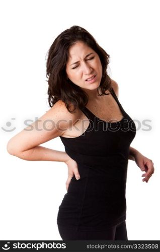 Beautiful woman holding her back with pain and ache due to injury,wearing a sporty black tank top, isolated.