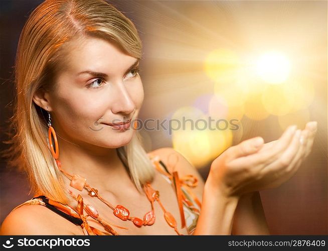 Beautiful woman holding magic lights in her hands