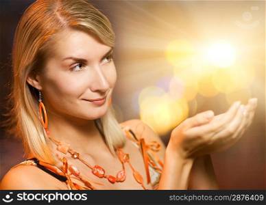 Beautiful woman holding magic lights in her hands