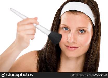 Beautiful woman holding make-up brush on white background