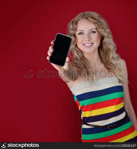Beautiful woman holding mobilephone towards camera
