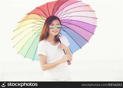 Beautiful woman holding rainbow colorful umbrella. Travel Concept.