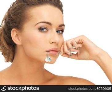 beautiful woman holding shiny diamond necklace in mouth. woman with diamond necklace