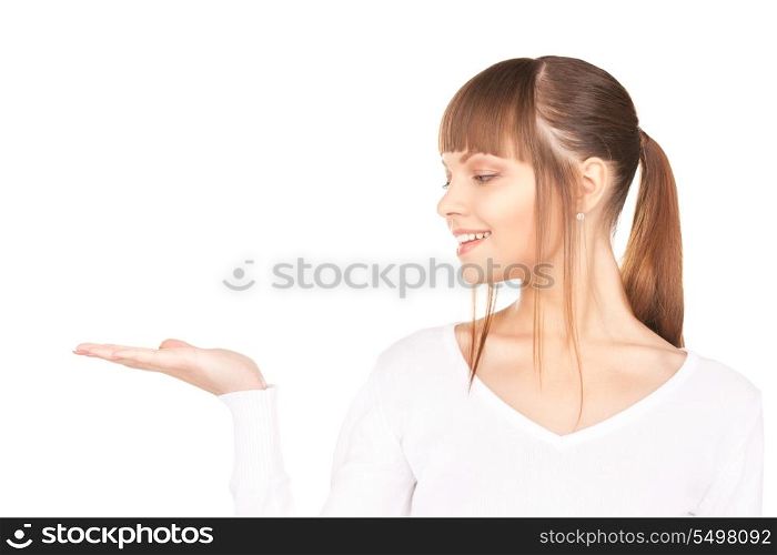 beautiful woman holding something on the palm of her hand