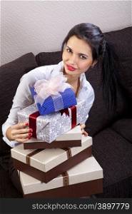 beautiful woman holds many holiday boxes with ribbon