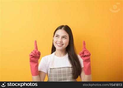 Beautiful woman housekeeper portrait on yellow background