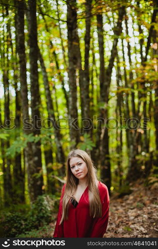 Beautiful woman in a beautiful forest in autumn