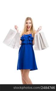 Beautiful woman in a blue dress with a happy face holding shopping bags, isolated on a white background