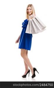 Beautiful woman in a blue dress with shopping bags, isolated on a white background