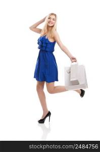 Beautiful woman in a blue dress with shopping bags, isolated on a white background